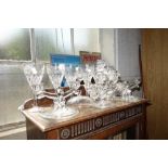 A SET OF SIX CUT GLASS WINE GOBLETS and three glass candelabra