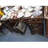 A REPRODUCTION MAHOGANY PEDESTAL DESK 134 cm wide