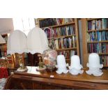 A PAIR OF ONYX TABLE LAMPS, another similar and a collection of glass shades