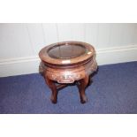 A CHINESE HARDWOOD STAND of circular form, 31 cm high x 36 cm dia.