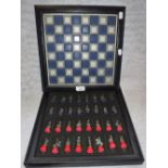 A WHITE METAL AND ENAMEL CHESS SET, MODELLED AS FIGURES FROM THE NAPOLEONIC WARS, cased