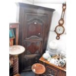 A 19TH CENTURY FRENCH OAK CORNER CUPBOARD, the carved door fitted a heavy iron lock, 100 cms wide