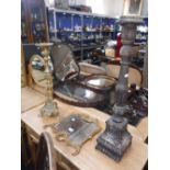 A BRASS FRAMED ROCOCO MIRROR, a brass church candlestick and a large wooden candlestick (3)