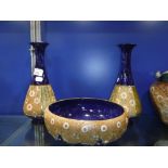 A PAIR OF EDWARDIAN ROYAL DOULTON GLAZED STONEWARE VASES, 27.5 cm high and a similar bowl, 23 cm