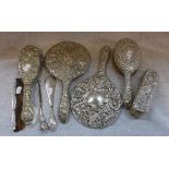 AN EMBOSSED SILVER-BACKED DRESSING TABLE SET