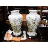 A PAIR OF "FRANKLIN PORCELAIN" VASES, "The Spring Glen Vase" and "The Autumn Glen Vase" on wooden