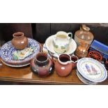 A QUANTITY OF CERAMICS to include a majolica charger, terracotta jugs and a stoneware flagon
