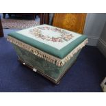 A 19TH CENTURY SARCOPHAGUS SHAPED UPHOLSTERED BOX OTTOMAN, with mahogany base and with needlework