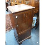 A GEORGE III MAHOGANY POT CUPBOARD with two doors enclosing an arrangement of shelves and drawers,