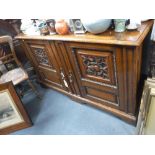 A VICTORIAN OAK SIDEBOARD, with carved panels and fitted interior trays, 135 cms wide