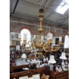 A SIX BRANCH BRASS CHANDELIER purchased from W Sitch & Co