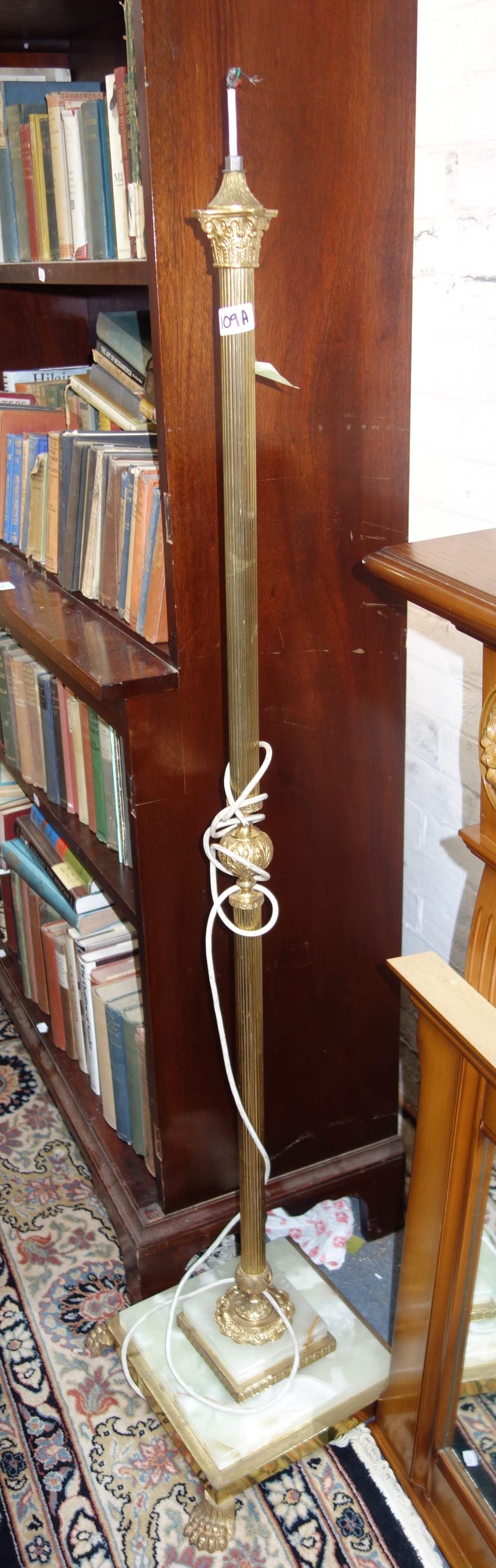 A BRASS AND ONYX STANDARD LAMP and a wrought-iron five branch chandelier with glass shades (2)