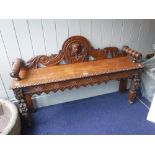 A VICTORIAN CARVED GOLDEN OAK HALL BENCH, 122 cms long