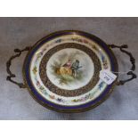 A 19TH CENTURY CONTINENTAL PORCELAIN PLATE decorated with a courting couple inset in an ormolu two