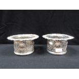 A PAIR OF 19TH CENTURY SILVER PLATED BOTTLE STANDS