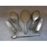 A SILVER-BACKED DRESSING TABLE SET and a button hook