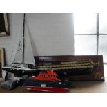 A HALF MODEL OF HMS VICTORY, mounted on a mahogany board, a model lifeboat and a Mariner model