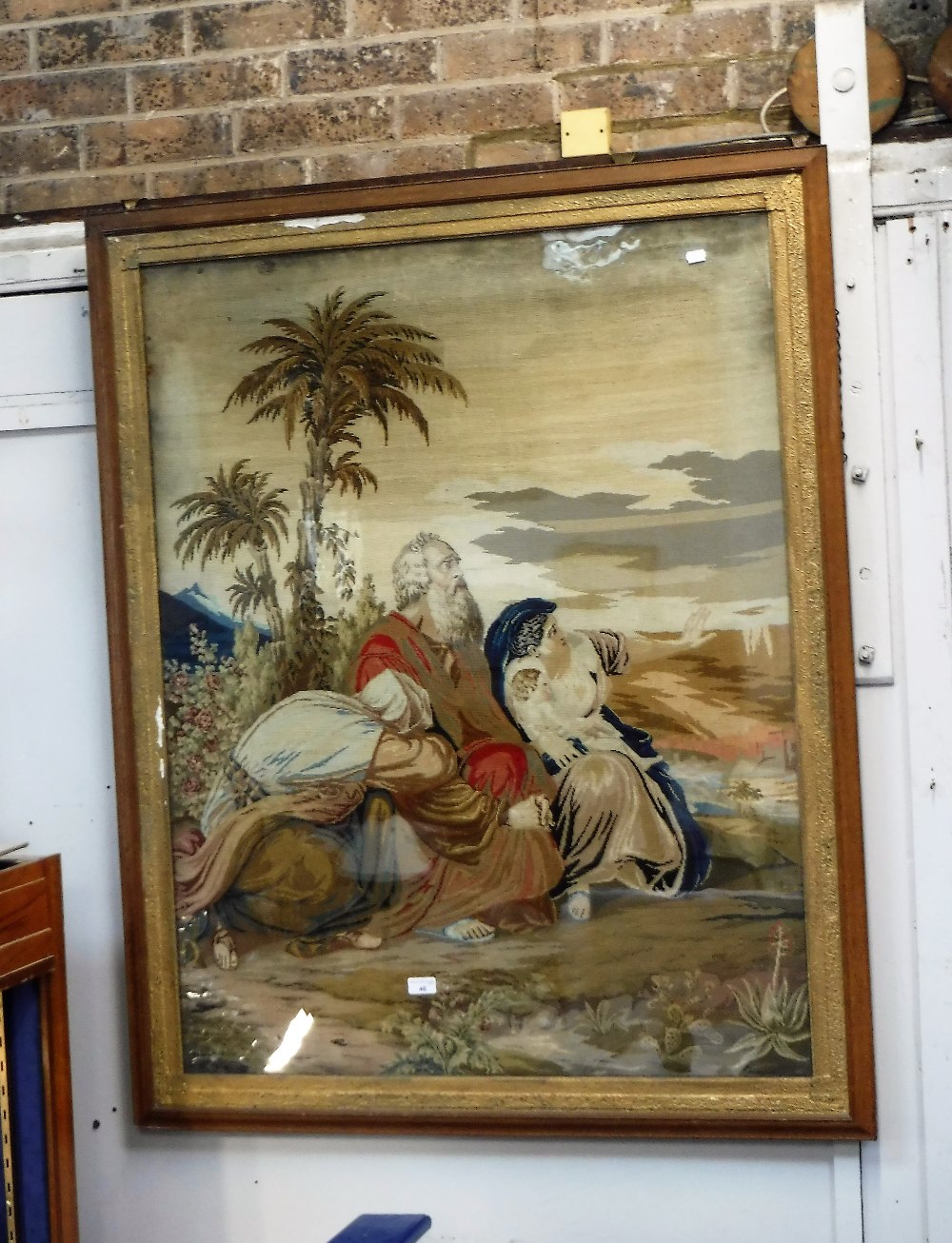 A LARGE VICTORIAN NEEDLEWORK depicting "The flight into Egypt", 127 cm high