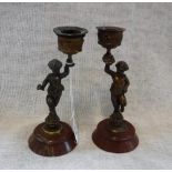 A PAIR OF 19TH CENTURY CHERUB CANDLESTICKS on rouge marble bases, 16.5 cm