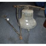 A 19TH CENTURY SCHOOL BELL on an iron swinging bracket with long handle