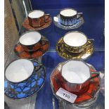 SIX ROSENTHAL COFFEE CUPS AND SAUCERS in various colours with pierced silver overlay