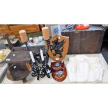 A CARVED OAK BOOKRACK, iron candlesticks, Naval shields and sundries