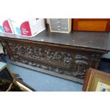 A CONTINENTAL OAK COFFER, the front and sides formed with re-used carved panels depicting The Last