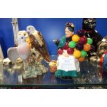 A ROYAL DOULTON FIGURE, "The Old Balloon Seller" and a Beswick study of lovebirds (repaired) (2)