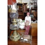 A RESIN STUDY OF A FLOWER GIRL on a marble base, 32 cm high and a Victorian oil lamp with a cut