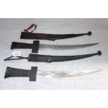 TWO AFRICAN DAGGERS in leather scabbards