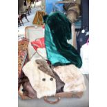 A VINTAGE GREEN VELVET CAPE and similar clothing contained in a leather suitcase