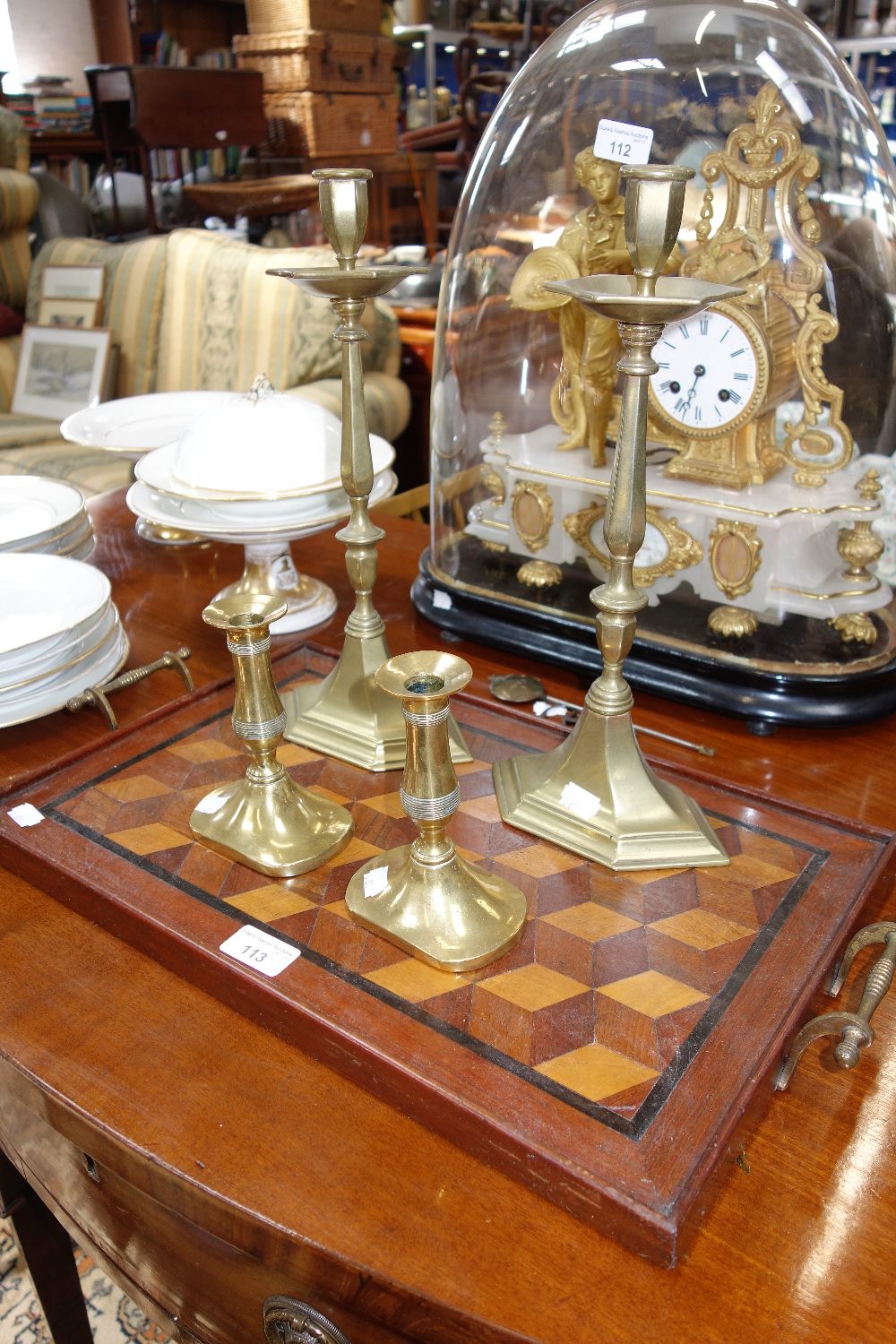 AN EDWARDIAN PARQUETRY TRAY and two pairs of brass candlesticks