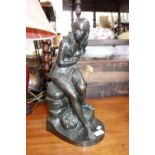 A 19TH CENTURY BRONZE STUDY of a young woman seated on rocks, 42 cm high