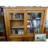 A REPRODUCTION OAK CABINET, with sliding glazed doors above two doors with fielded panels, 165 cm