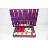 A CHESS, DRAUGHTS AND BACKGAMMON SET, in a part fitted box, with bezique slides