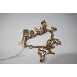 A 9 CT GOLD CHARM BRACELET, with eleven charms all hallmarked 9 ct, approximately 34.4 grams