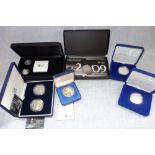A COLLECTION OF COINS in fitted presentation cases