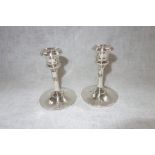 A PAIR OF CANDLESTICKS, on circular leaded bases, 11 cms high