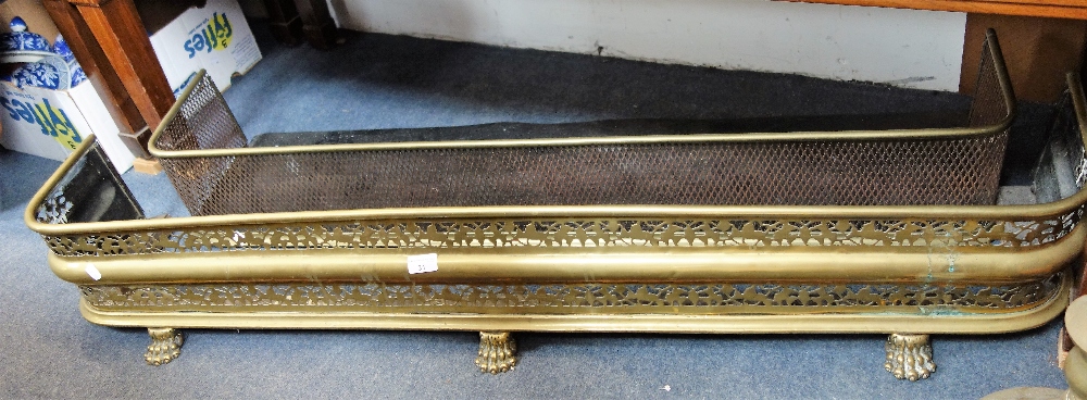 A 19TH CENTURY BRASS AND STEEL FENDER 122 cm wide, and a brass fender with paw feet 137 cm wide