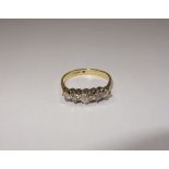 A FIVE STONE DIAMOND RING, on an 18 ct yellow gold shank, ring size M