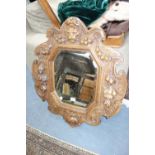 A VICTORIAN WALL MIRROR in an ornate carved oak frame with animal mask and fruit decoration, 86 cm