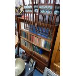 AN EDWARDIAN OAK BOOKCASE, with Arts and Crafts handles to the doors below