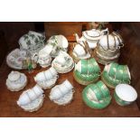 A COLLECTION OF WEDGWOOD GREEN AND GILT TEAWARE and similar ceramics