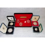 A COLLECTION OF COINS in fitted presentation cases