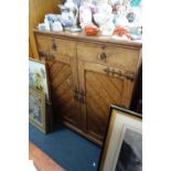 A VICTORIAN GOTHIC STYLE OAK CUPBOARD, fitted two drawers over a pair of doors enclosing slides,