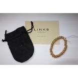 LINKS 'SWEETIE' ROLLED GOLD BRACELET, the circular charms on an expanding circumference band, one