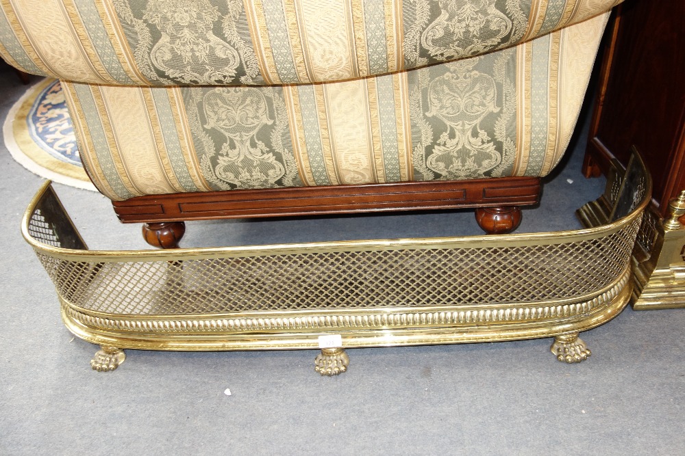 A REGENCY PIERCED BRASS FENDER, 112 cm wide and another similar, 142 cm wide