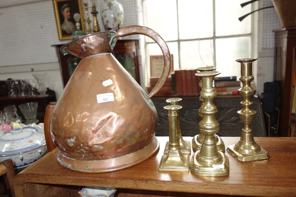 A 19TH CENTURY COPPER "2 GALLON" SACK MEASURE and a collection of brass candlesticks