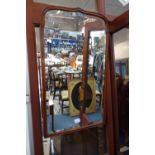 AN EDWARDIAN MAHOGANY FRAMED MIRROR, with shaped plate, other mirrors and a section of oak carving