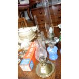 A VICTORIAN BLUE GLASS OIL LAMP and similar oil lamps with a collection of spare chimneys